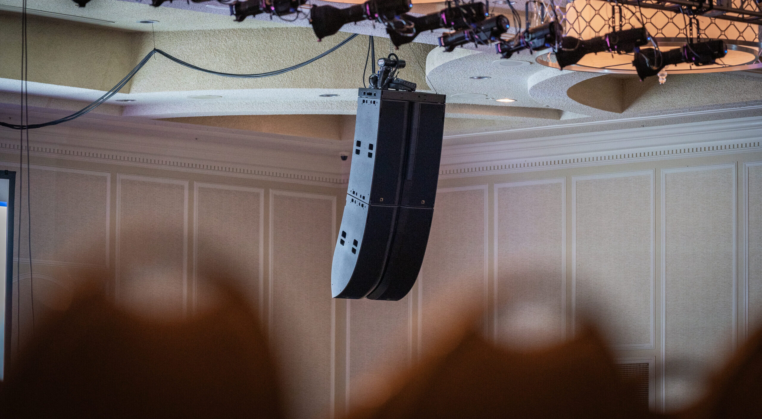 An L-Acoustics L2 Loadspeaker hanging in a ballroom