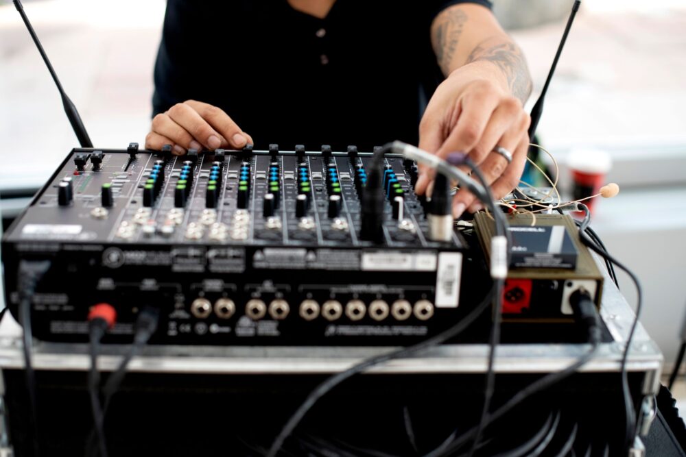 Person Adjusting a Digital Mixing Console